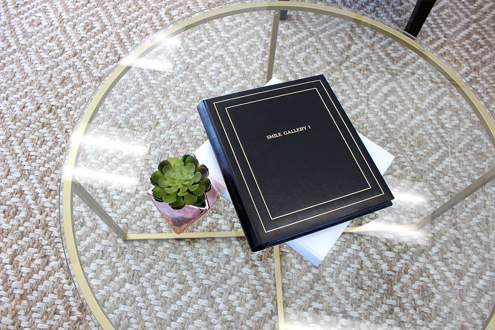 table with a book and plant on top of it