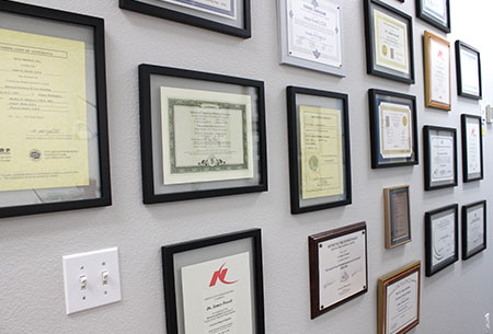 dental diplomas and accolades on a wall