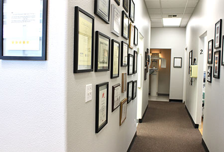 hallway of exceptional dentistry, with diplomas and accolades on the wall