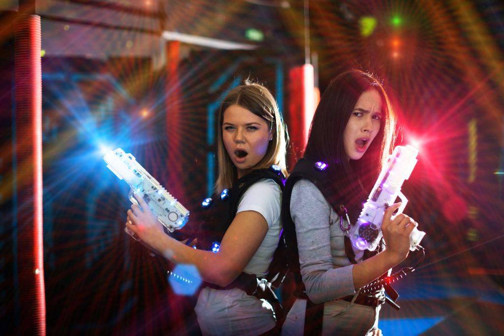 young women playing laser tag